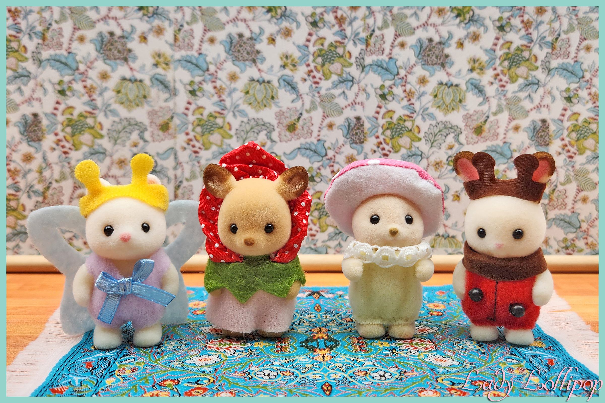 Four different Sylvanian Families babies all dressed up in their forest costumes